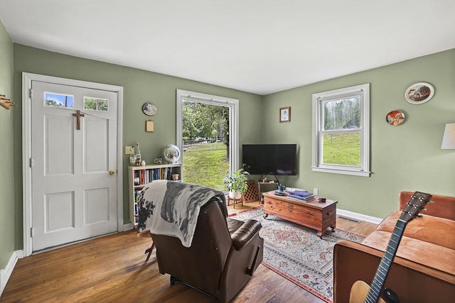 living room featuring wood finished floors and baseboards