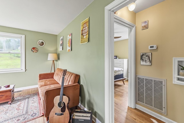 sitting room with wood finished floors and baseboards