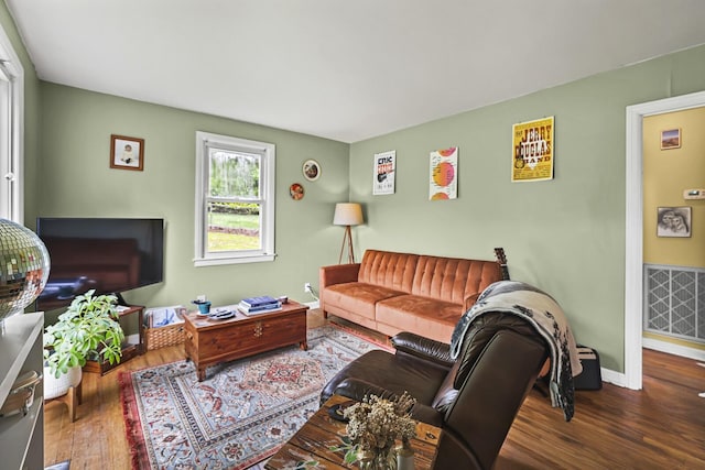 living room with hardwood / wood-style floors and baseboards
