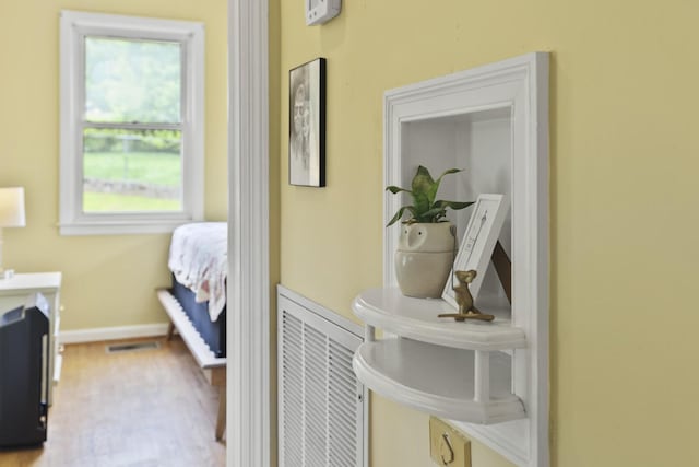 bedroom featuring baseboards and wood finished floors