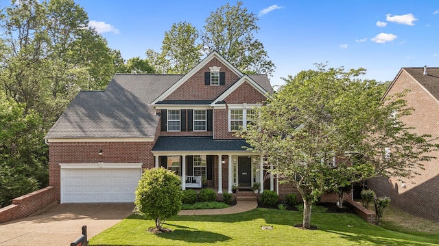 1308 Beech Hollow Dr, Nashville, TN 37211 - view of front of home with brick siding, driveway, an attached garage, a front yard, and covered porch