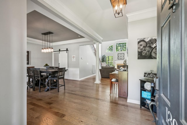1308 Beech Hollow Dr, Nashville, TN 37211 - foyer with a barn door, wood finished floors, a raised ceiling, crown molding, and ornate columns