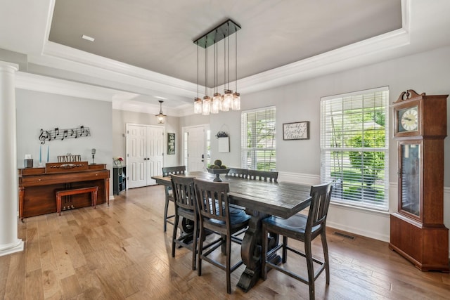 1308 Beech Hollow Dr, Nashville, TN 37211 - dining room featuring a tray ceiling, ornate columns, wood-type flooring, baseboards, and crown molding