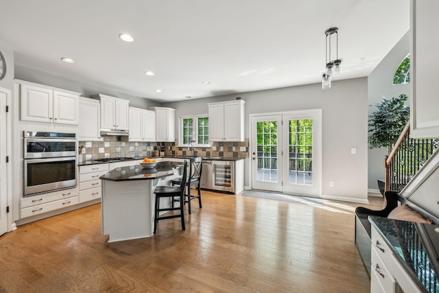 1308 Beech Hollow Dr, Nashville, TN 37211 - kitchen featuring appliances with stainless steel finishes, dark countertops, a sink, backsplash, and beverage cooler