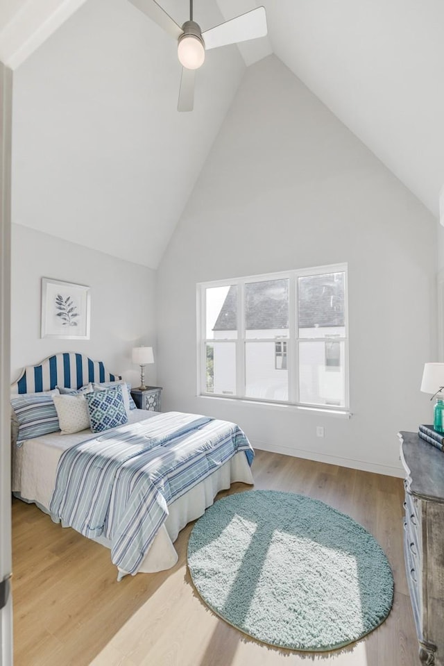 bedroom featuring high vaulted ceiling, wood finished floors, and ceiling fan