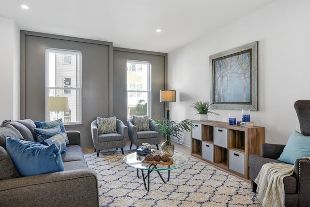living area with recessed lighting, wood finished floors, and baseboards