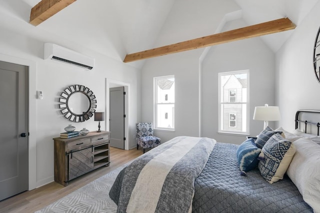 bedroom featuring a wall mounted AC and light wood finished floors