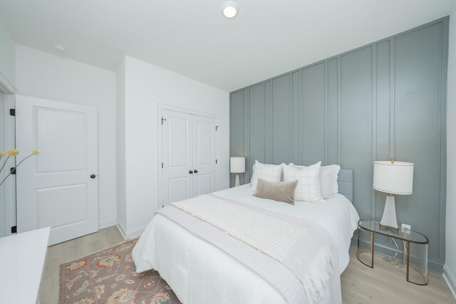 5329 Bridgemore Blvd, Murfreesboro, TN 37129 - bedroom with light wood-style flooring, a closet, baseboards, and a decorative wall