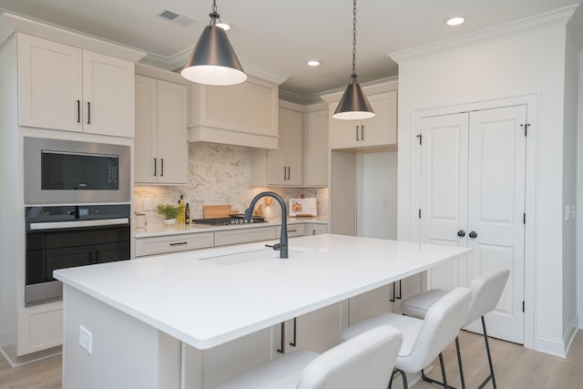 5329 Bridgemore Blvd, Murfreesboro, TN 37129 - kitchen with appliances with stainless steel finishes, a sink, ornamental molding, backsplash, and a center island with sink