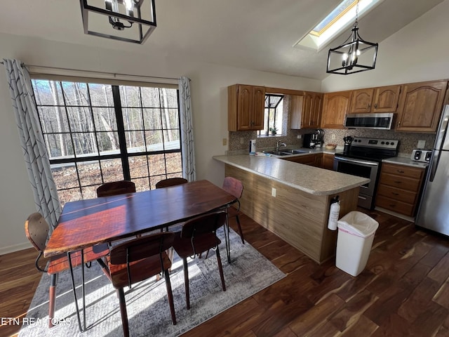 518 Deer Path Ln, Gatlinburg, TN 37738 - kitchen featuring stainless steel appliances, a peninsula, a sink, decorative backsplash, and light countertops