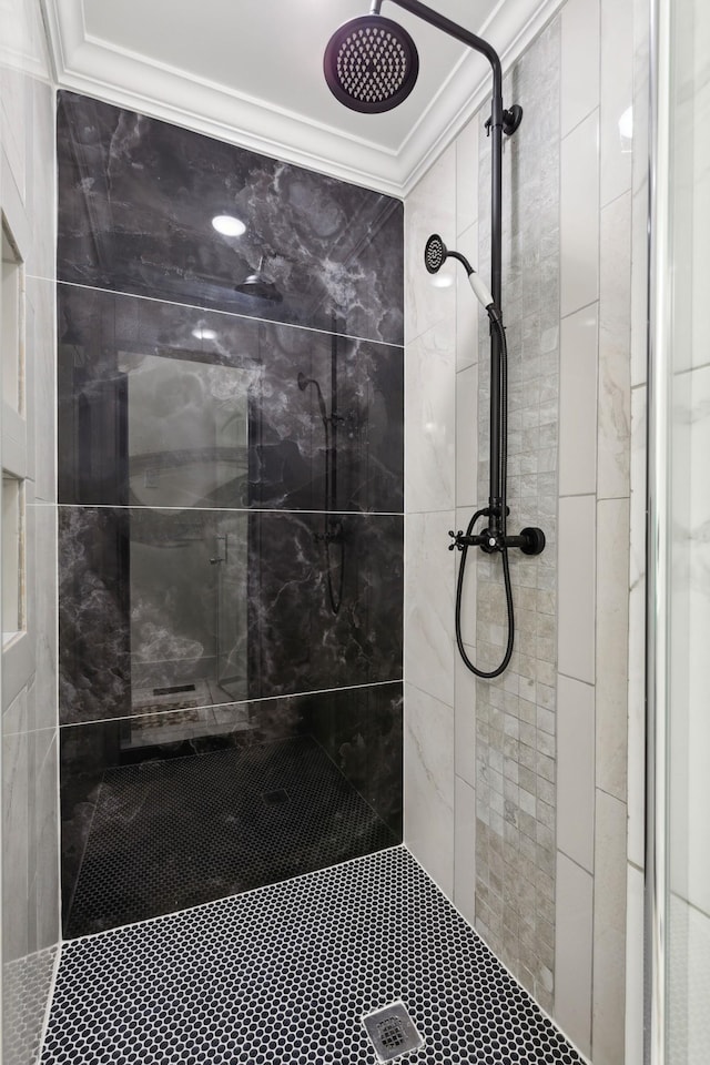 full bathroom featuring ornamental molding and tiled shower