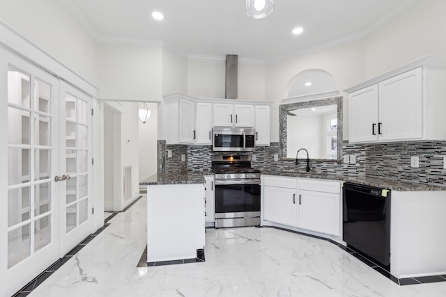 kitchen featuring appliances with stainless steel finishes, tasteful backsplash, ornamental molding, white cabinets, and recessed lighting