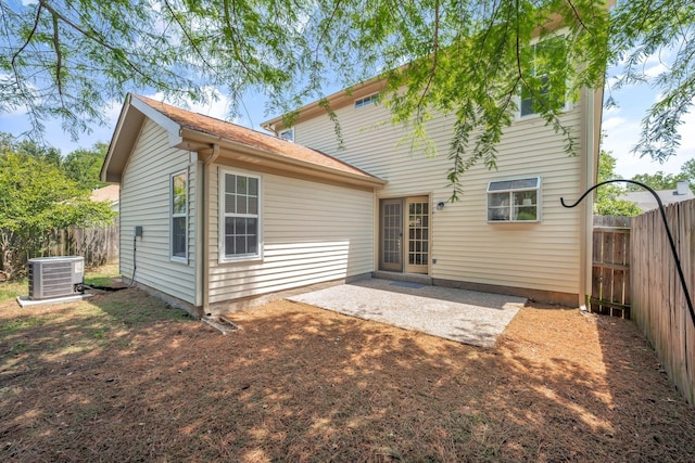 rear view of property featuring central air condition unit, a fenced backyard, and a patio area