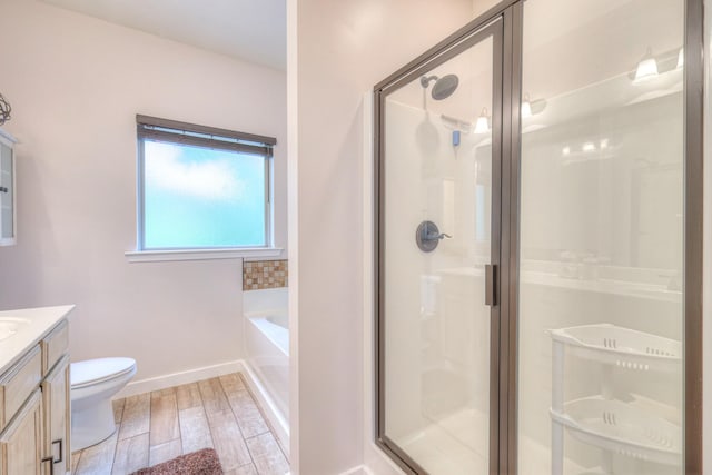 1008 Beverly Ln, Spring Hill, TN 37174 - bathroom with vanity, a shower stall, a bath, toilet, and wood finished floors