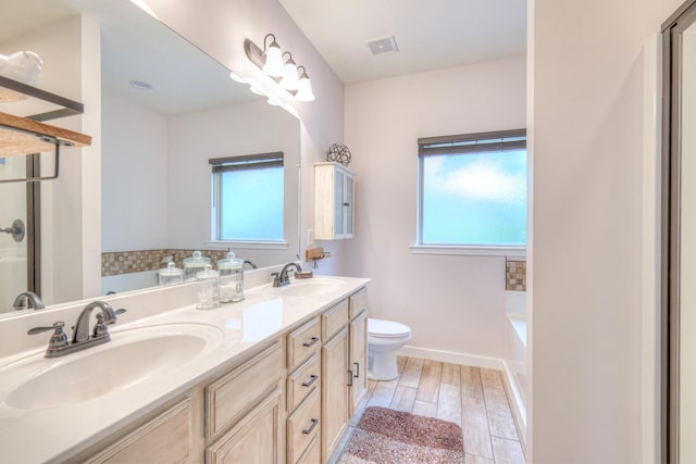 1008 Beverly Ln, Spring Hill, TN 37174 - bathroom with plenty of natural light, toilet, double vanity, and a bath