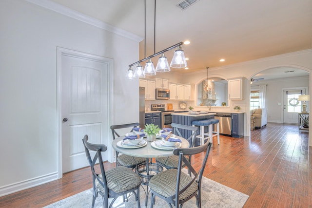 1008 Beverly Ln, Spring Hill, TN 37174 - dining area with arched walkways, crown molding, baseboards, wood finished floors, and recessed lighting