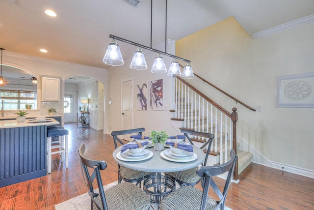 1008 Beverly Ln, Spring Hill, TN 37174 - dining area with arched walkways, ornamental molding, baseboards, wood finished floors, and stairs