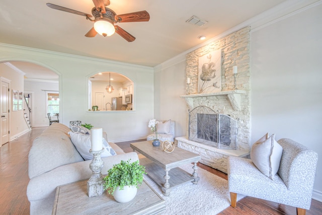 1008 Beverly Ln, Spring Hill, TN 37174 - living room with ornamental molding, a ceiling fan, wood finished floors, a stone fireplace, and baseboards