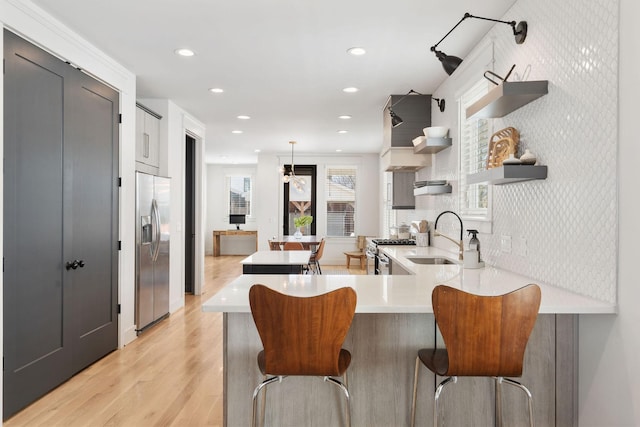 6003B Pennsylvania Ave, Nashville, TN 37209 - kitchen featuring open shelves, stainless steel appliances, light countertops, recessed lighting, and a peninsula