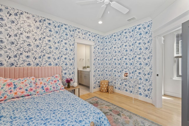 6003B Pennsylvania Ave, Nashville, TN 37209 - bedroom with wood finished floors, wallpapered walls, baseboards, ceiling fan, and ensuite bathroom