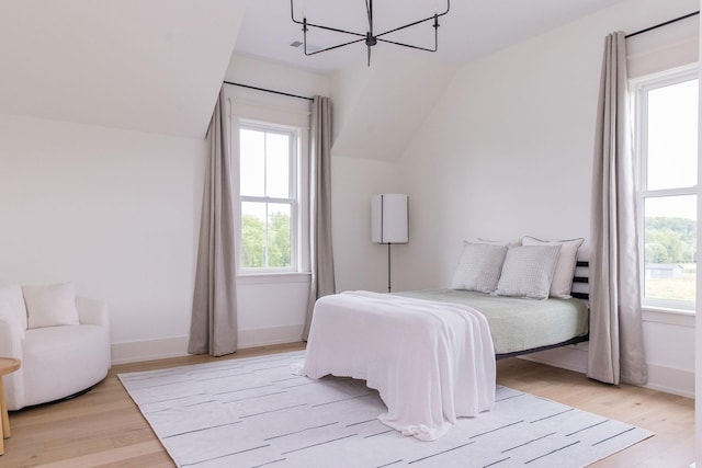 2576 Goose Creek Byp, Franklin, TN 37064 - bedroom with a chandelier, vaulted ceiling, light wood-style floors, and baseboards