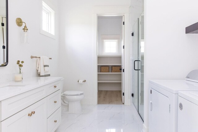 2576 Goose Creek Byp, Franklin, TN 37064 - bathroom featuring washer and dryer, a stall shower, marble finish flooring, vanity, and toilet