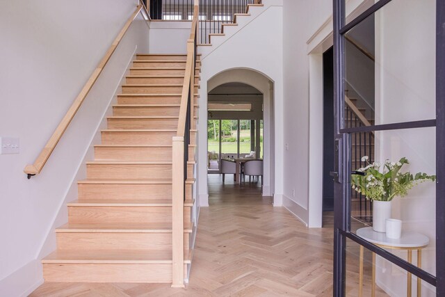 2576 Goose Creek Byp, Franklin, TN 37064 - stairway featuring arched walkways, a towering ceiling, and baseboards
