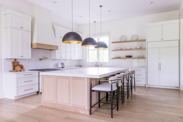 2576 Goose Creek Byp, Franklin, TN 37064 - kitchen featuring light wood-type flooring, custom exhaust hood, a large island, open shelves, and white cabinets