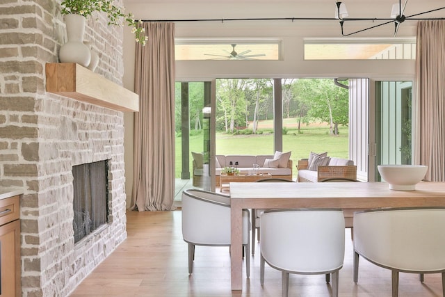 2576 Goose Creek Byp, Franklin, TN 37064 - dining room featuring plenty of natural light, light wood-style floors, a chandelier, and a fireplace