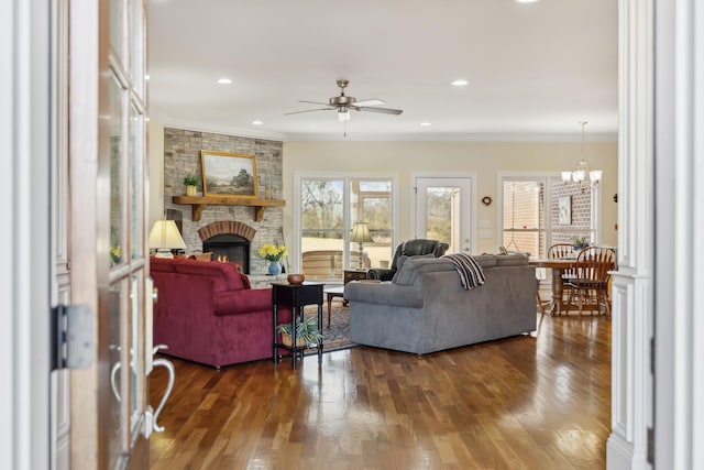 6611 Arno College Grove Rd, College Grove, TN 37046 - living room featuring ceiling fan, a large fireplace, dark wood finished floors, a chandelier, and ornamental molding