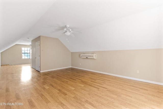 338 Lindsey Mill Cir, Rocky Top, TN 37769 - additional living space with an AC wall unit, a ceiling fan, light wood-style floors, lofted ceiling, and baseboards