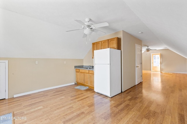 338 Lindsey Mill Cir, Rocky Top, TN 37769 - kitchen with freestanding refrigerator, ceiling fan, lofted ceiling, light wood-style floors, and a sink