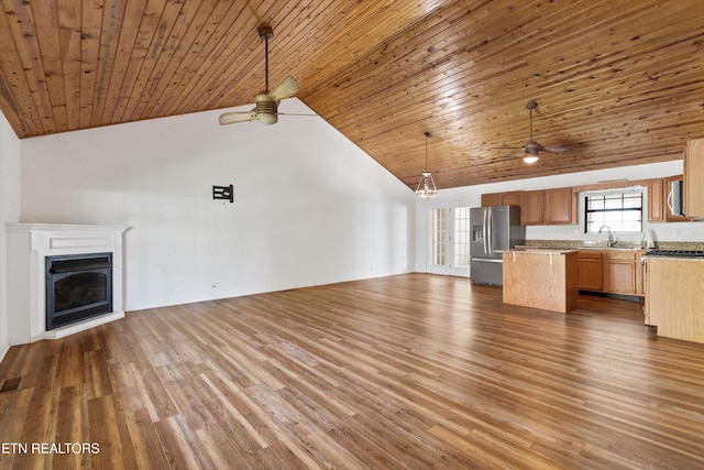 338 Lindsey Mill Cir, Rocky Top, TN 37769 - unfurnished living room featuring ceiling fan, a fireplace, wooden ceiling, a sink, and wood finished floors