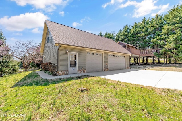 338 Lindsey Mill Cir, Rocky Top, TN 37769 - view of home's exterior featuring driveway, a lawn, roof with shingles, stone siding, and a deck