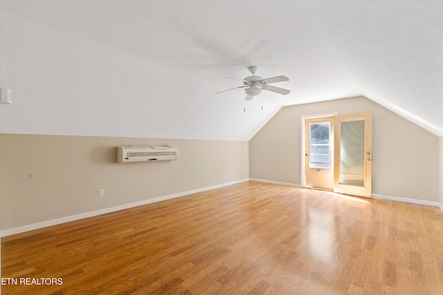 338 Lindsey Mill Cir, Rocky Top, TN 37769 - additional living space with a wall mounted AC, ceiling fan, light wood finished floors, vaulted ceiling, and baseboards