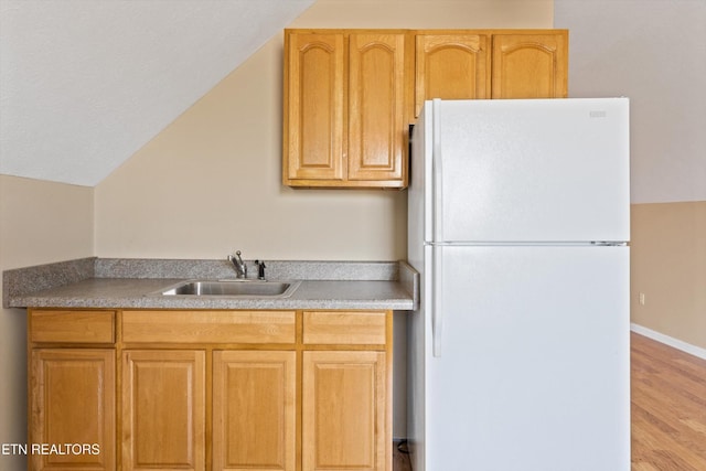 338 Lindsey Mill Cir, Rocky Top, TN 37769 - kitchen with freestanding refrigerator, a sink, light wood-style flooring, vaulted ceiling, and light countertops