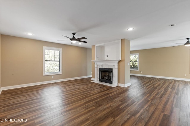 338 Lindsey Mill Cir, Rocky Top, TN 37769 - unfurnished living room with ceiling fan, a fireplace, dark wood-style floors, baseboards, and recessed lighting