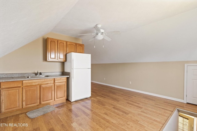 338 Lindsey Mill Cir, Rocky Top, TN 37769 - kitchen featuring freestanding refrigerator, a sink, lofted ceiling, light wood finished floors, and ceiling fan