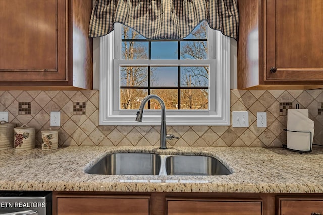 5606 Bridgehampton Dr, Powell, TN 37849 - kitchen with a sink, light stone counters, and tasteful backsplash