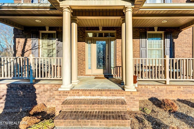 5606 Bridgehampton Dr, Powell, TN 37849 - view of exterior entry with a porch and brick siding