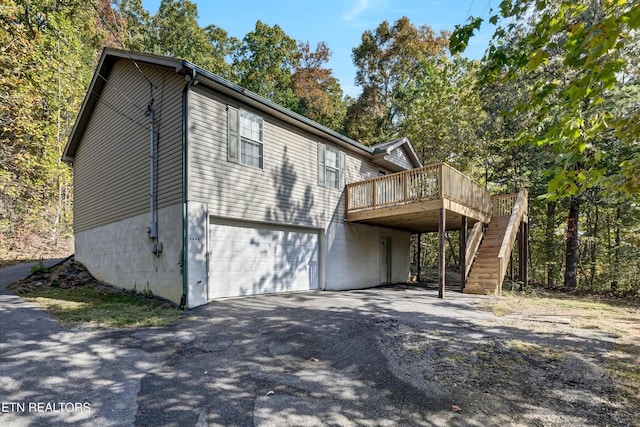 2406 Rowena Ln, Knoxville, TN 37931 - view of property exterior with a wooden deck, stairway, an attached garage, and driveway
