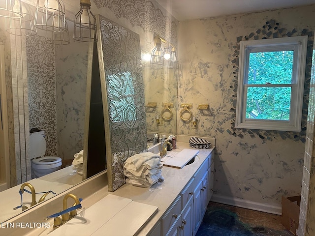 1939 Pinewood Cv, Cleveland, TN 37312 - full bath with wallpapered walls, baseboards, toilet, and double vanity