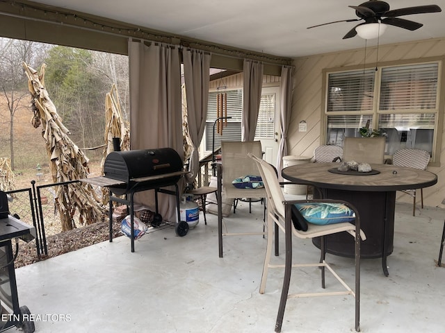 view of patio featuring outdoor dining area, ceiling fan, and area for grilling