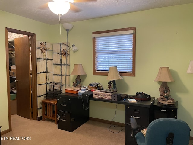 office area featuring light colored carpet, ceiling fan, and baseboards