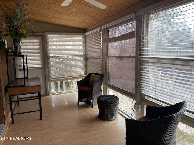 sunroom / solarium featuring plenty of natural light, vaulted ceiling, wood finished floors, and wooden ceiling