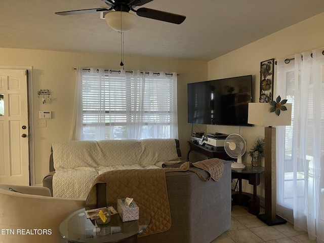 living room with ceiling fan and light tile patterned floors