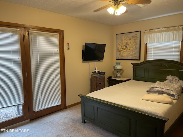 bedroom with light carpet, baseboards, and a ceiling fan