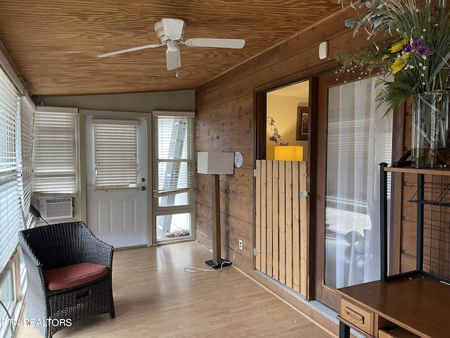 sunroom with lofted ceiling, cooling unit, and ceiling fan