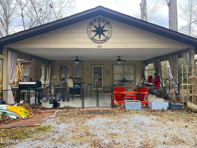 view of front of home with ceiling fan and a patio area