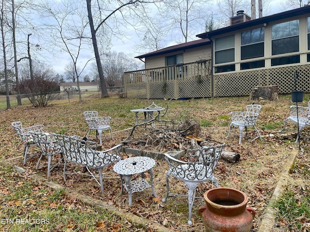 view of yard with a deck and fence